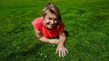 glücklich jung Frau im ein rot Hemd genießen ein sonnig Tag auf ein Grün Wiese, Ideal zum Konzepte verbunden zu Jugend, Freizeit, und Sommer- Aktivitäten foto