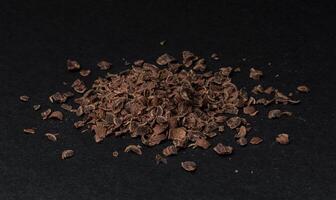 Stapel von Boden Schokolade auf schwarz Hintergrund foto