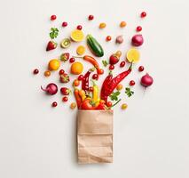 ai generiert frisch organisch Gemüse und Früchte verschütten von umweltfreundlich Papier Tasche auf Weiß Hintergrund foto