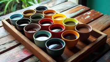ein hölzern Tablett gefüllt mit anders farbig Kaffee Tassen jeder halten ein anders brauen von ein tropisch Insel foto