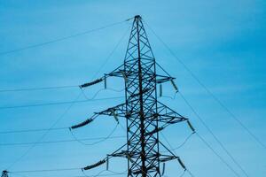 hoch Stromspannung Türme mit Himmel Hintergrund. Leistung Linie Unterstützung mit Drähte zum Elektrizität Übertragung. hoch Stromspannung Gitter Turm mit Draht Kabel beim Verteilung Bahnhof. Energie Industrie, Energie Speichern foto