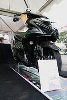 Surabaya, Indonesien. September 8, 2023 - - Yamaha Aerox Motorrad mit Monster- Logo Aufkleber auf Anzeige beim das Auto Show foto