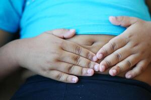 Kind Leiden Bauch Schmerzen schließen hoch. foto