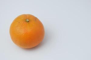 Foto von ein völlig runden Orange mit ein Weiß Hintergrund