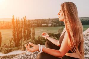 Fitness Frau. glücklich mittleren Alters Fitness Frau tun Dehnen und Pilates auf ein Felsen in der Nähe von Wald beim Sonnenuntergang. weiblich Fitness Yoga Routine. gesund Lebensstil mit Fokus auf Wohlbefinden und Entspannung. foto