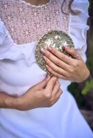 schön Frau im Weiß Jahrgang Kleid mit Zug und halten Jahrgang Spiegel im Frühling Garten beim Sonnenuntergang foto