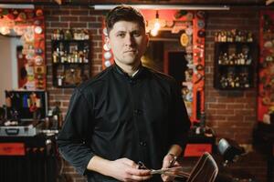 Friseur. Salon zum Männer. Friseur Konzept. gut aussehend Mann mit Barbier Werkzeug. Fachmann Bart und Haar Pflege. foto