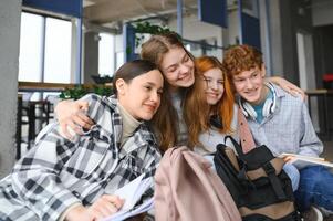 glücklich vielfältig Hochschule Studenten posieren zum Gruppe Porträt, suchen beim Kamera, lächelnd foto