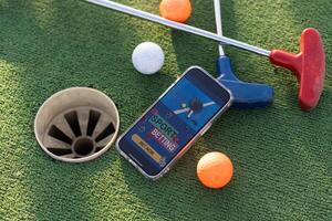 Mini Golf Sport Wetten auf ein Smartphone foto