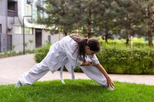 jung Mädchen im ein Weiß Kimono, Karate foto