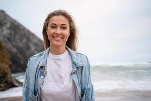 lächelnd Frau im Denim Hemd genießen Sommer- Ferien beim Strand foto