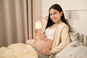 schön schwanger Frau bewirbt sich feuchtigkeitsspendend, strecken Kennzeichen Sahne auf Bauch, Fruchtbarkeit Unfruchtbarkeit Behandlung, In-vitro-Fertilisation, Zukunft Mutterschaft Konzept foto