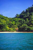 Antenne Panorama von Thailands grün, üppig tropisch Insel, National Park Insel, mit Blau und Aquamarin das Meer, und Wolken leuchtenden durch Sonnenlicht im das Hintergrund. foto