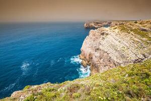 hoch Klippen und Blau Ozean beim cabo sao Vicente auf Küste von Portugal foto