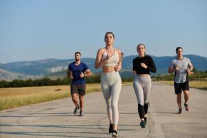 ein Gruppe von freunde pflegt ein gesund Lebensstil durch Laufen draußen auf ein sonnig Tag, Verbindung Über Fitness und genießen das energetisierend Auswirkungen von Übung und Natur foto