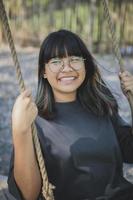 Glück lächelndes Gesicht des asiatischen Teenagers im offenen Park foto