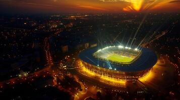 ein Antenne Aussicht von ein Stadion zündete oben mögen ein Leuchtfeuer es ist Flutlichter Gießen ein hell glühen Über das Umgebung Bereich foto