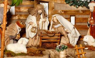 Puppenkomposition der Geburt Christi mit dem Jesus, der Jungfrau Maria, dem Joseph, einer Krippe, Stroh und den Magiern, die kamen.