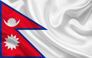 nepal landesflagge auf gewelltem seidenstoff hintergrundpanorama foto