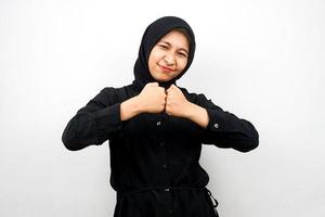 schöne und fröhliche junge asiatische muslimische frau, mit geballten händen, sieg, isoliert auf weißem hintergrund foto