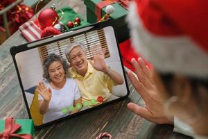 Weihnachts- und Neujahrs-Videoanruf mit der Familie mit Tablet zusammen zu Hause foto