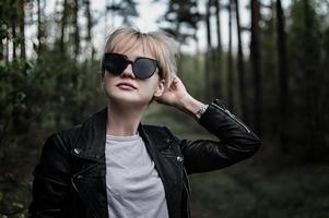 Mädchen mit Sonnenbrille im Wald foto