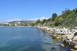 Meerblick vom Ufer mit Deichen, die die Küste und das Meer schützen. weiches blaues ruhiges Wasser mit kleinen Wellen. entspannende Meereslandschaft. Kristallklares Wasser des Schwarzen Meeres in Balchik, Bulgarien. foto