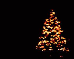 Orange Unschärfe Weihnachtsbeleuchtung background.abstract Lichter unscharf Unschärfe Lichtpunkte schwarz. foto