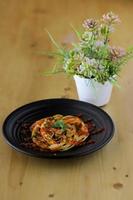 leckerer kleiner Kuchen und Schokolade auf Teller mit Blumenhintergrund auf dem Tisch foto