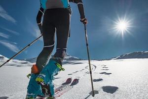 Skibergsteiger klettert auf Spuren mit Robbenfell foto