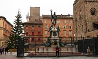 bologna, italien, 2021, der nettunobrunnen und der geschmückte kiefernweihnachtsbaum bei tag in bologna. Italien foto