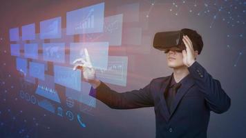 Geschäftsmann, der mit futuristischen Virtual-Reality-Brillen arbeitet. Analysen auf dem digitalen Bildschirm mit Finanzdiagrammen. modernes Geschäftskonzept.