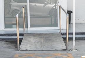 Gebäudeeingangspfad mit Rampe für ältere oder nicht selbsthilfefähige Behinderte im Rollstuhl. foto