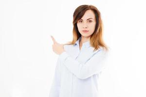 Porträt einer modernen, sexy Frau im Hemd, die mit dem Finger auf weißen Hintergrund zeigt. Geschäftsfrau. Selbstbewusster junger Manager, Kopierraum foto