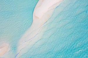 sommer seelandschaft schöne wellen, blaues meerwasser am sonnigen tag. Draufsicht von der Drohne. Meerblick, erstaunlicher tropischer Naturhintergrund. schönes helles Meer mit spritzenden Wellen und Strandsandkonzept foto