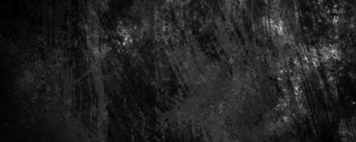 schwarzer betonzement defokussierter hintergrund mit dunkelgrauen rissen und zerknitterten falten foto