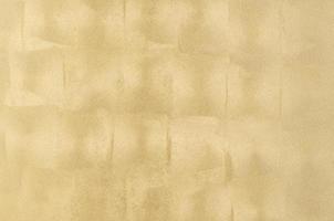 Hintergrund der verputzten Textur mit goldener Marmoreffektfarbe. künstlerischer hintergrund handgemacht foto