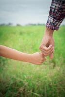 Nahaufnahme des Vaters, der seine Tochter an der Hand hält, so süß, Zeit mit der Familie. foto