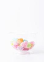 Fruchtgummi mit herzförmigen Süßigkeiten auf weißem Hintergrund foto
