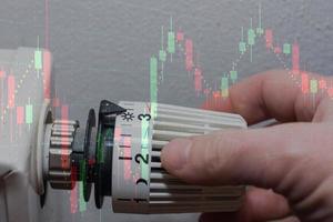 die energiepreise steigen und der energieverbrauch schaltet einen thermostatregler mit einem diagramm ein foto