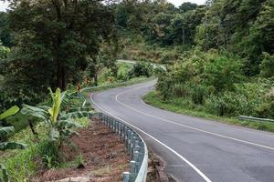 kurvenreiche Straße auf dem Gipfel des Berges im tropischen Regenwald in der Provinz Nan foto