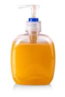 lastische Flasche der orangefarbenen transparenten Flüssigseife isoliert auf weißem Hintergrund foto