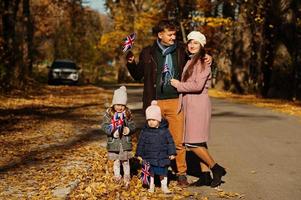 Nationalfeiertag des Vereinigten Königreichs. Familie mit britischen Flaggen im Herbstpark. Britentum feiert Großbritannien. zwei Kinder. foto