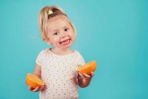 lächelndes Baby mit einer Orange foto