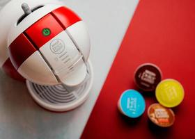 Nescafe Dolce Gusto Kaffeemaschine mit Nescafe Dolce Gusto Kapseln. selektiver Fokus foto