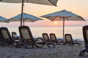 Malerischer Blick auf den privaten Sandstrand am Strand mit Sonnenliegen gegen das Meer und die Berge. amara dolce vita luxushotel. Erholungsort. tekirowa-kemer foto