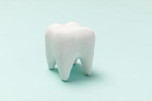Gesundheitszahnpflegekonzept. weißes gesundes Zahnmodell isoliert auf pastellblauem Hintergrund. Zahnaufhellung, zahnärztliche Mundhygiene, Zahnsanierung, Zahnarzttag. Platz kopieren. foto