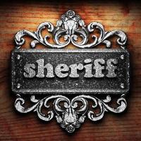 Sheriff-Wort aus Eisen auf Holzhintergrund foto