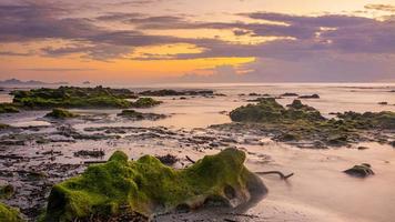 Sonnenuntergang Landschaft auf den Strandfelsen im Vordergrund foto