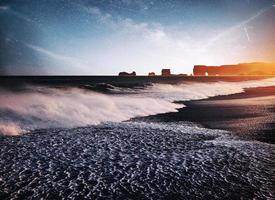 die Felsentrollzehen. Reynisdrangar-Klippen. schwarzer Sandstrand. Island. fantastischer Sternenhimmel und die Milchstraße foto